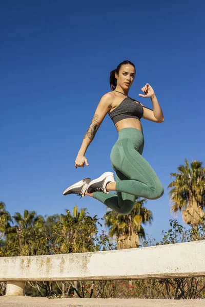 sporty woman doing jumping exercises, woman jumping, lifestyle