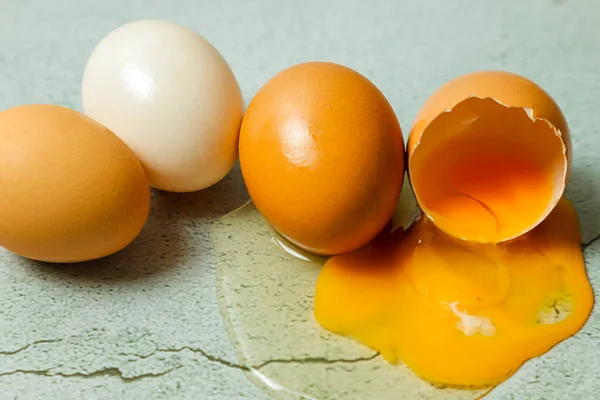 group of fresh eggs on top, cracked egg
