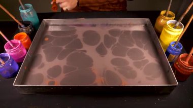 Bir süs sanatı olan mermer sanatı. Tragacanth ile yoğunlaştırılmış sudaki boyalarla desenler oluşturuyor ve bu desenleri kağıda aktarıyor..