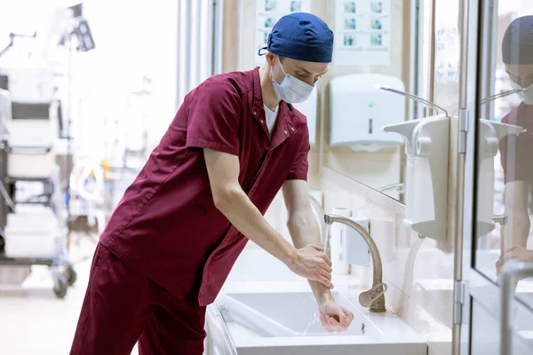 male surgeon washes his hands before surgery, doctor\'s sterile hands