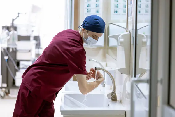 male surgeon washes his hands before surgery, doctor\'s sterile hands