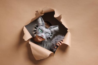 quadrobics portrait, Teenager in cat mask on beige background, studio photo, clipart