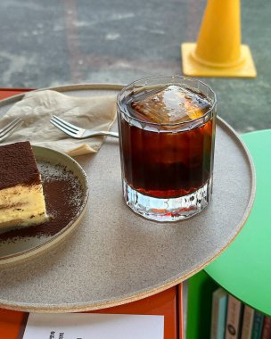 kahve ve kek bir tabak üzerinde ahşap masada.