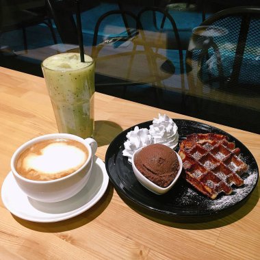 Bir fincan kahve, bir bardak süt ve bir kaşık.