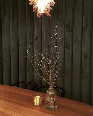 Bir ağaç ve ahşap bir lambayla güzel bir iç mekan.