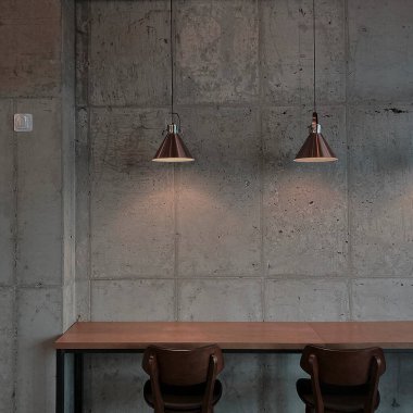 Koyu kahverengi ahşap masa ve lamba ile modern çatı katının iç tasarımı.