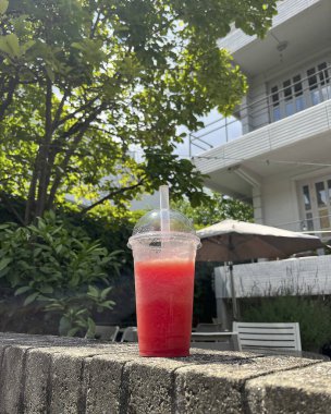 Sahilin arka planında buzlu kırmızı şarap kadehi