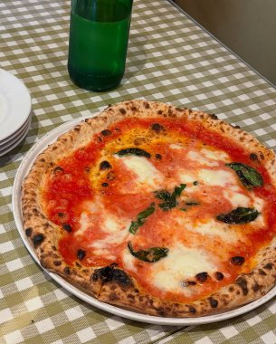 Domates soslu İtalyan pizzası, fesleğen ve mozzarella peyniri.