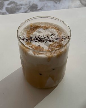 Süt ve buz küplü bir bardak buzlu kahve.
