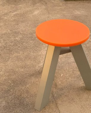 Parkın beton zemininde turuncu metal sandalye