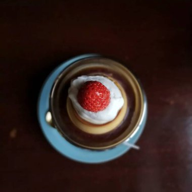 Beyaz bir kek ve bir fincan kahvenin dikey yakın çekimi.