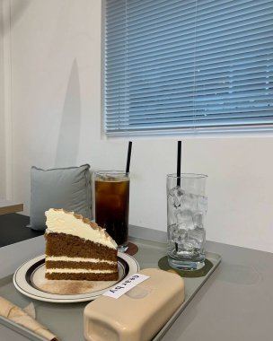 a cup of coffee and a cake on a table