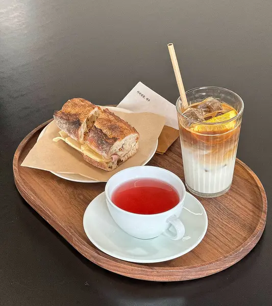 Bir bardak çay ve ahşap bir masada bir fincan kahve.