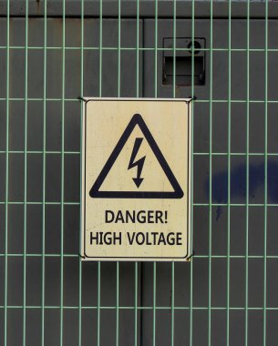 Metal bir ızgarada yüksek voltaj işareti