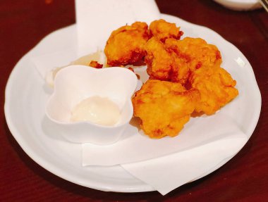 Soslu ve peynirli kızarmış tavuk kanadı.