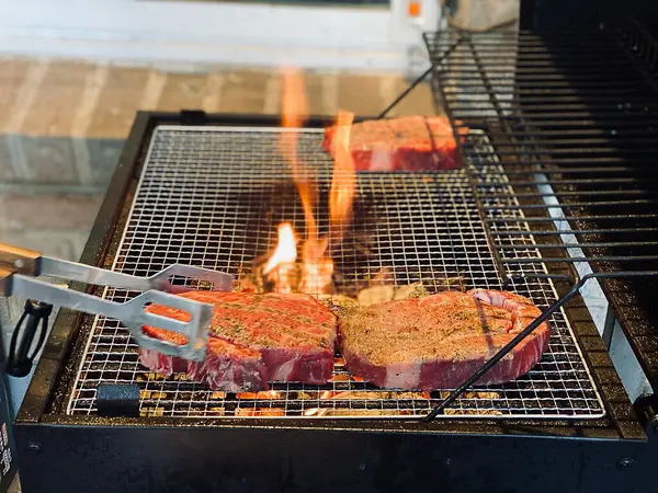 Kömür ızgarasında bir parça et ve ateş.