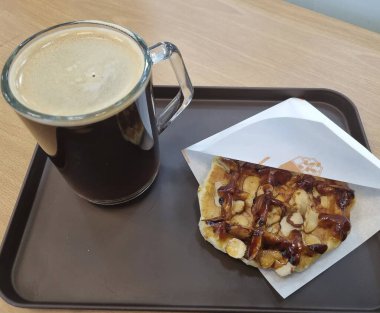 Tahta arka planda kahve ve çikolatalı kek.