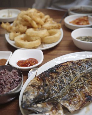 grilled fish with spices and vegetables on a plate