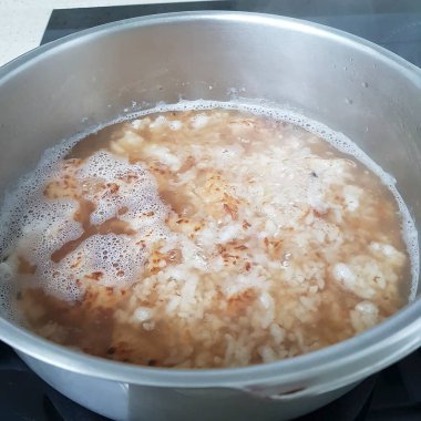fried rice with vegetables and spices in a pan