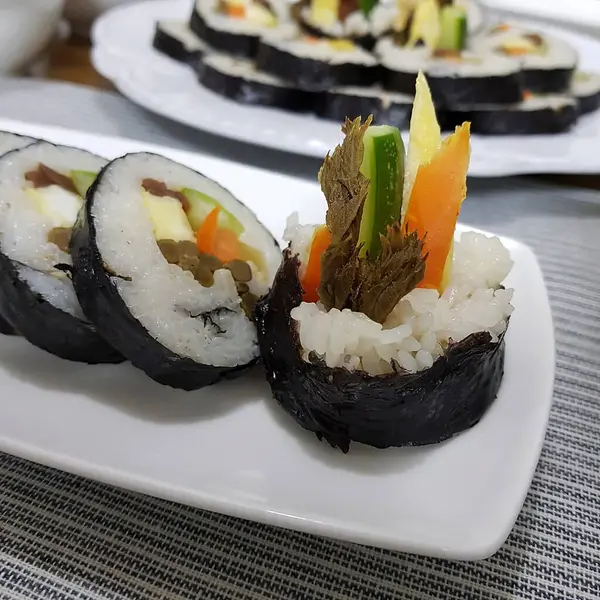 Beyaz tabakta servis edilen lezzetli suşi. Japon yemeği.