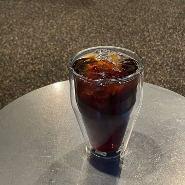 Masanın üzerinde buz küpleri olan cam ve cam.