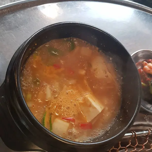 Tavada tavuk ve sebzeli sıcak çorbayı yakın.