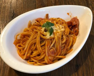 bir tabakta domates soslu spagetti.