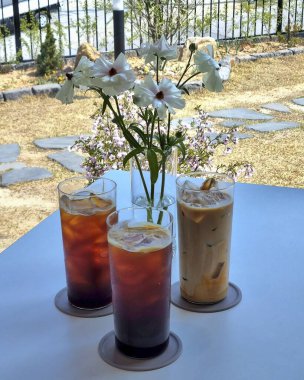 Kahve fincanı ve çiçekli içecek.