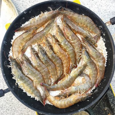 Tavada pişen taze karidesler.