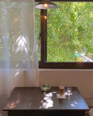 coffee cup and glass of wine on wooden table in cafe