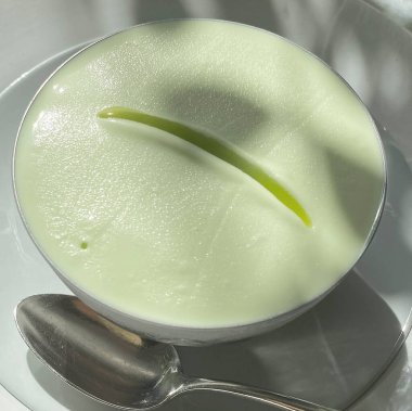 Kremalı yeşil çay ve yeşil yaprak beyaz seramik kasede