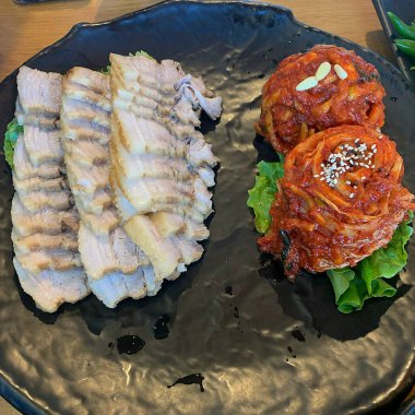 korean food, fried chicken with vegetables and sauce.
