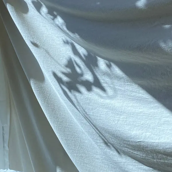 Gri arkaplanda gölgeler olan beyaz perde.