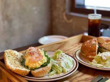 Tabakta et ve sebzeli sandviç.