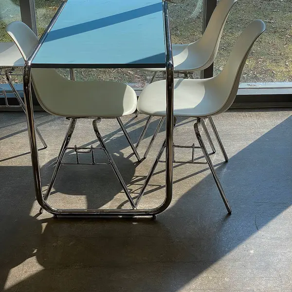 Modern kafe, sandalye ve cam kaplı masa.