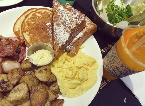 Tahta arka planda bir fincan çayla kahvaltı.