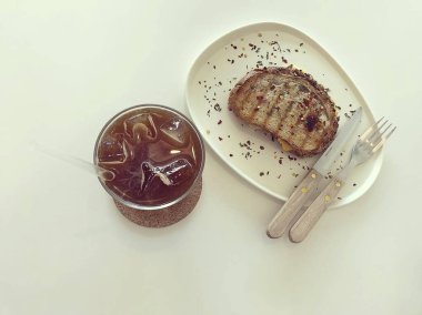 Kahve ve çay bir fincanda ve bir bardak süt tahta arka planda.