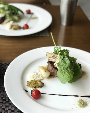 grilled steak with vegetables and salad