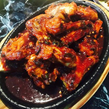 Soslu ve sebzeli kızarmış tavuk kanadı.