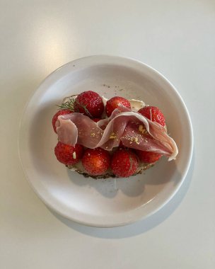 Beyaz bir tabak içinde taze çilek