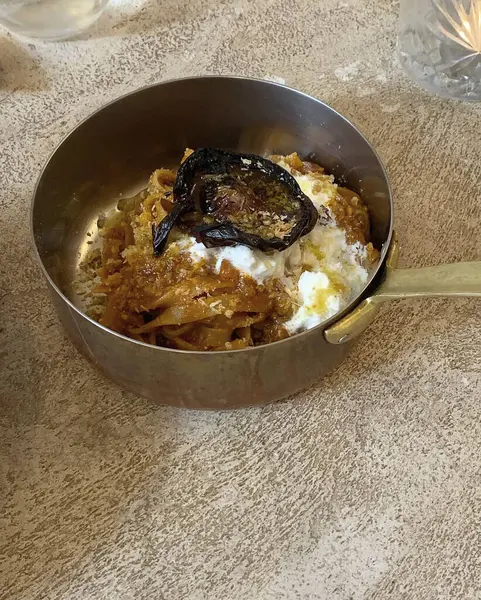 Bir tabak spagetti ve masanda kaşık olan yumurtanın yüksek açılı çekimi.