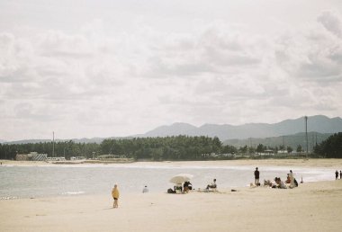 Akşamları kumsalın kumlu sahilinde yürüyen bir çift turist, tepeden bir manzara. yüksek kaliteli fotoğraf