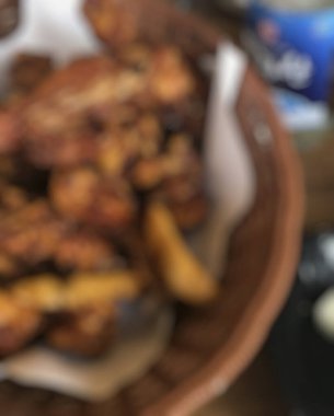 Tahta arka planda tavuk kanadı ve patates kızartması.