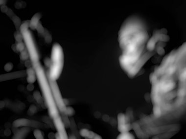 Bulanık arkaplan, çalan bir müzisyenin siyah beyaz fotoğrafı