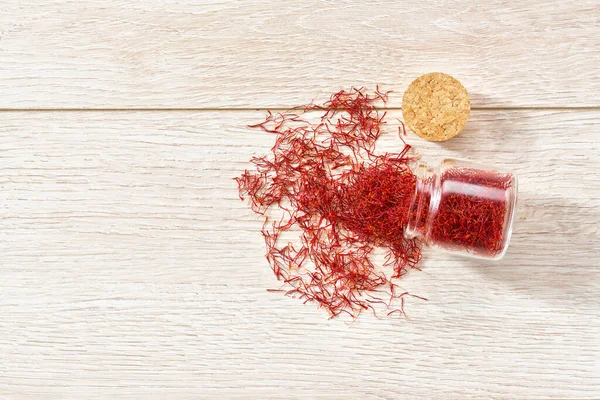Saffron Thread Spill Out Glass Storage Jar Wooden Table Copy — Stock Photo, Image