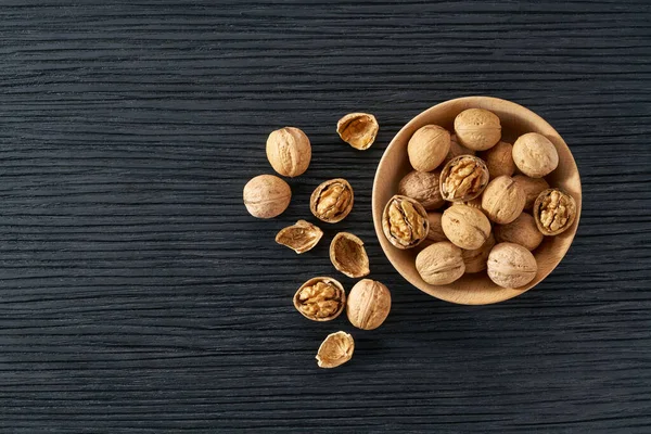 Wooden Plate Walnuts Nuts Black Table Space Text — Stock Photo, Image