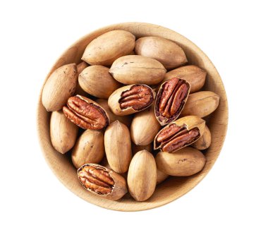 Wooden plate with organic pecan nuts  isolated on white background, top view.