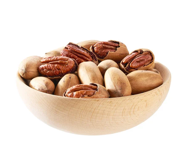 Wooden plate with organic pecan nuts isolated on white background, top view.