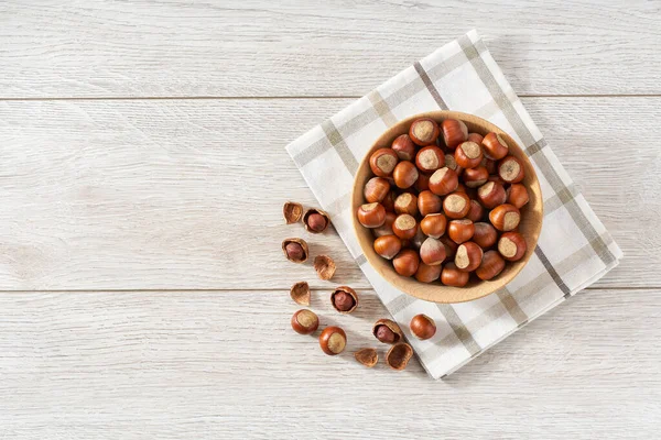 Wooden Plate Hazelnut Nuts White Table Space Text — Foto de Stock