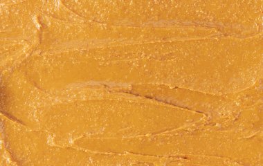 peanut creamy paste textured close up. close up close up peanut butter background .